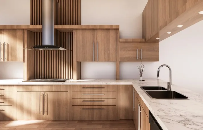 Cocina en L color roble claro con campana extractora cilíndrica y encimera de mármol blanco en Burgos
